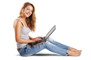 Smiling young woman using a laptop